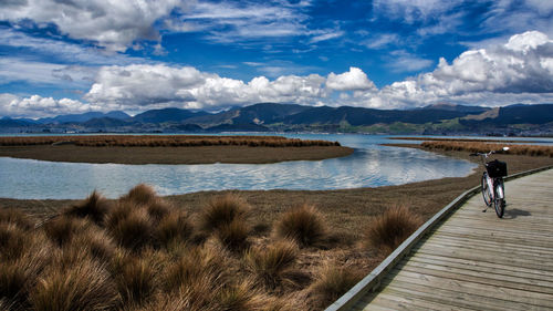 Scenic view of lake and mountains against sky