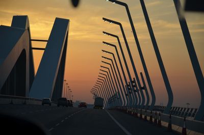 View of suspension bridge against cloudy sky