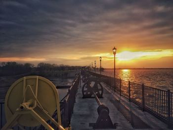 Man looking at sea against sky during sunset
