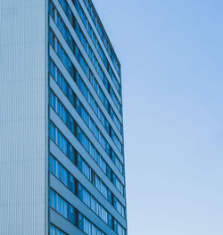 Low angle view of modern building against clear blue sky