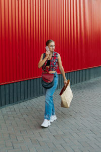 Full length of woman walking on footpath