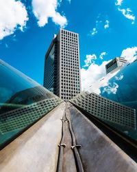 Low angle view of modern building against cloudy sky