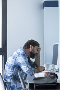 Side view of man working at home