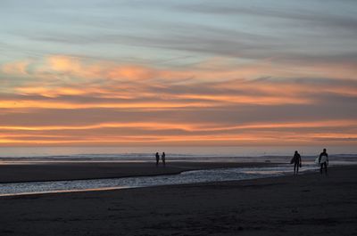 Scenic view of beach against sky during sunset