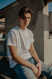 Portrait of young man sitting outdoors