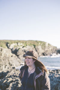 Woman standing on rock at beach