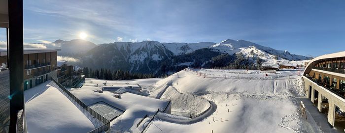 Panoramic view of snow covered mountains against sky