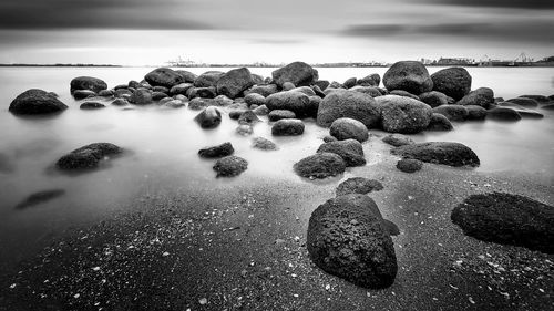 Pebbles on beach against sky