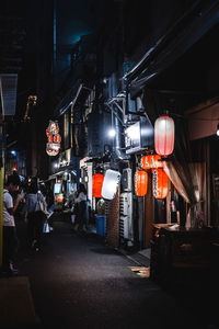 Lanterns hanging in city at night