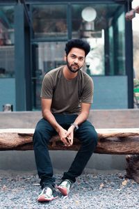 Portrait of man sitting on bench