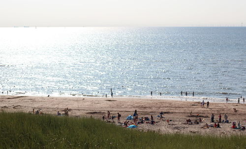 People on beach against sky