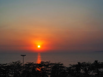 Scenic view of sea against romantic sky at sunset