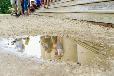 Reflection of built structure in puddle