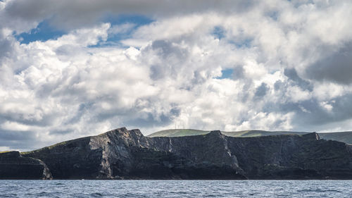 Scenic view of sea and mountains against sky