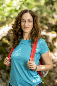 Backpacker woman posing on a mountain trail.