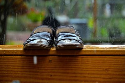 Slipper on wooden table during rainy season