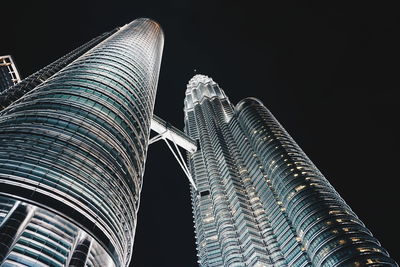 Low angle view of illuminated skyscraper against sky at night