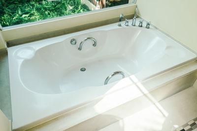 Bathtub by window at home