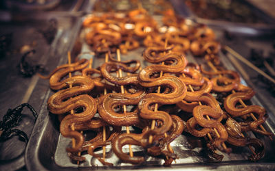 Close-up of fried snakes for sale in store