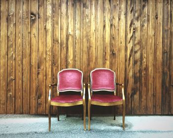 Chairs in front of wooden wall panel