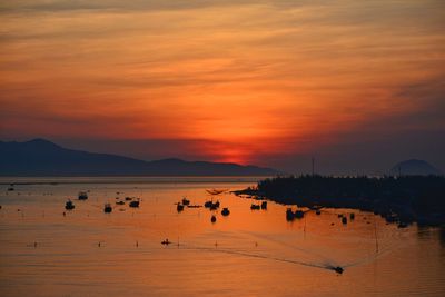 Scenic view of sea against orange sky