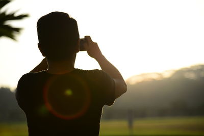 Photographer photographing through camera