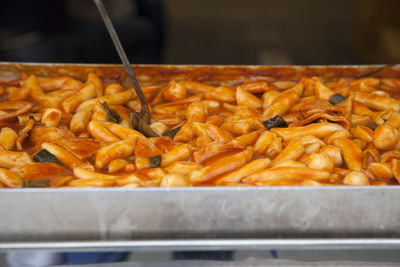 High angle view of fresh tteokbokki and ladle in tray