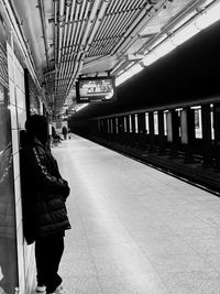 Rear view of people on railroad station platform