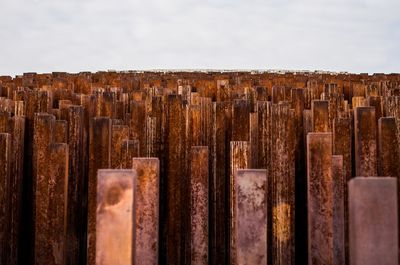 Close-up of posts against sky