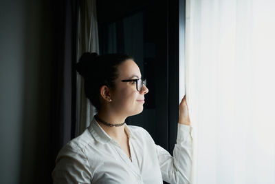 Young woman working with laptop in evening