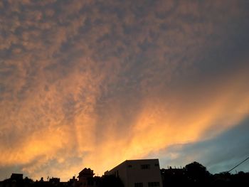 Low angle view of building against cloudy sky