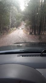 Road seen through wet windshield during rainy season