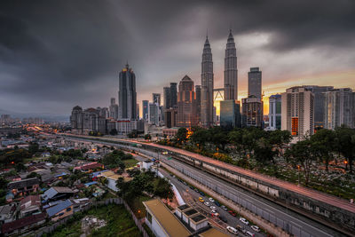 Panoramic view of buildings against cloudy sky