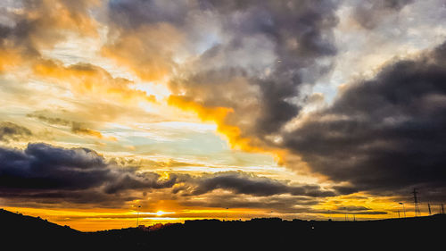 Low angle view of dramatic sky during sunset