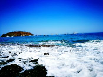 Scenic view of sea against blue sky