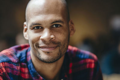 Portrait of mid adult man smiling in coffee shop