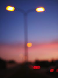 Defocused image of illuminated street lights at night