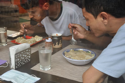 Men eating food at restaurant