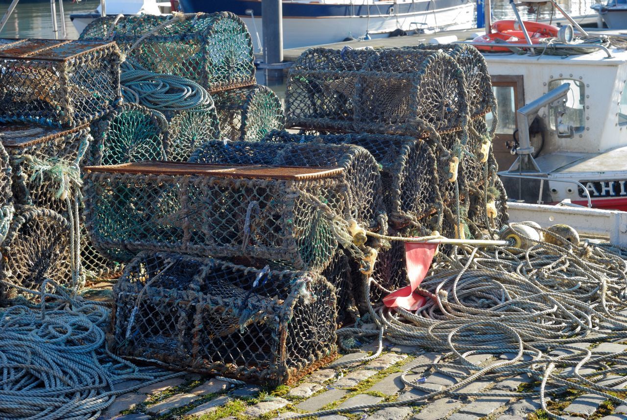 STACK OF FISHING NET ON HARBOR