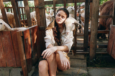 Portrait of young woman sitting on field