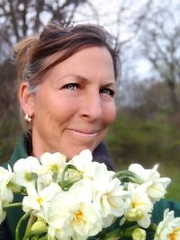 Close-up portrait of woman with pink flowers