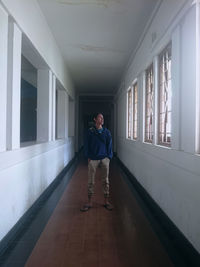 Full length portrait of man standing in building