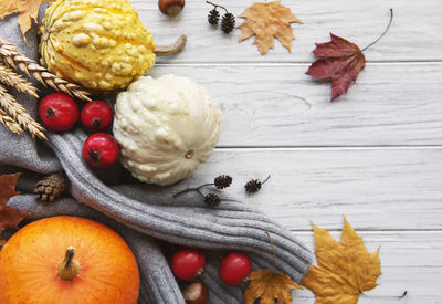 A rustic autumn still life with pumpkins on wooden background