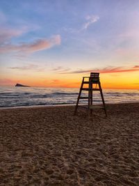 Scenic view of beach against sky during sunset