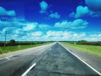 Empty road against cloudy sky