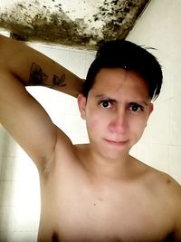 Portrait of shirtless young woman at home