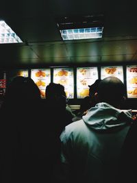 Rear view of people standing in city