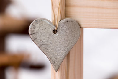 Close-up of heart shape hanging on paper