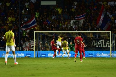 Group of people playing soccer on field