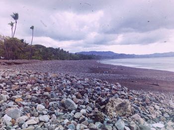 Scenic view of sea against cloudy sky